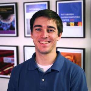 A photo portrait of a man with light skin tone and brown hair.