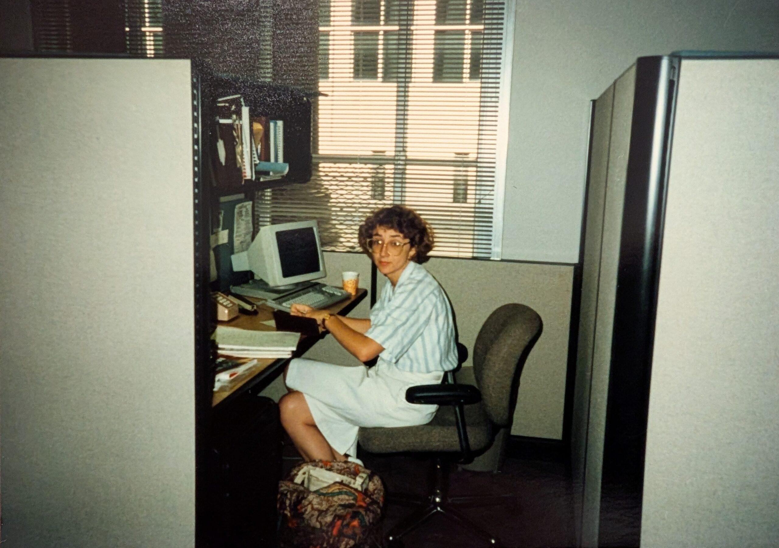 Deb at a computer with colleagues.